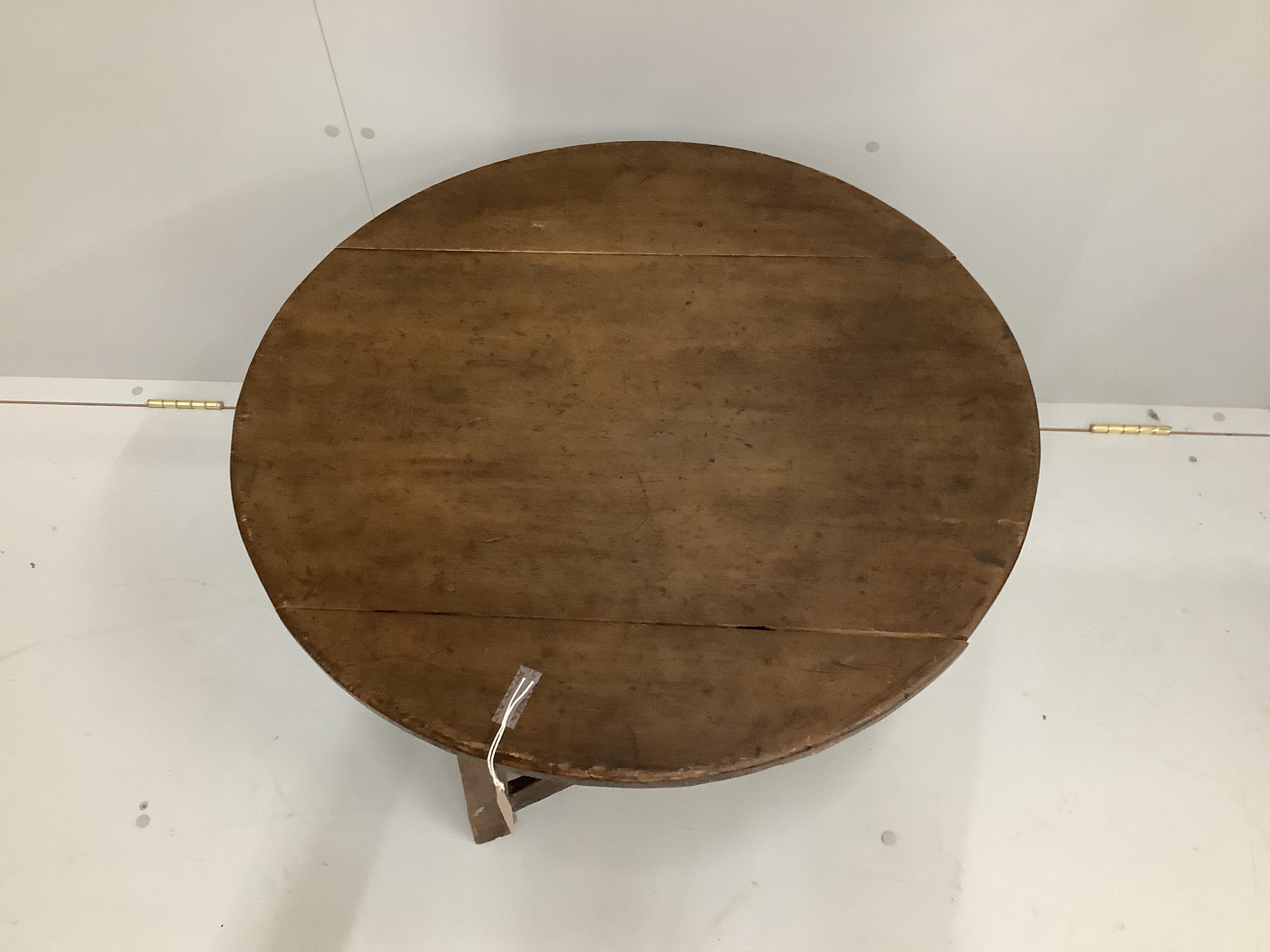 A 19th century and later circular oak and fruitwood cricket table, reduced, diameter 72cm, height 50cm